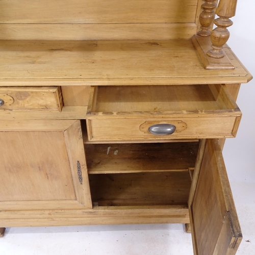 2073 - A Continental pine 2-section buffet, W130cm, H230cm, D42cm (with key)