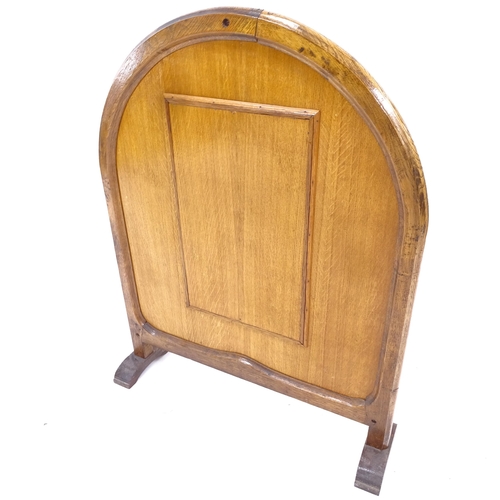 2076 - An early 20th century oak-framed fire screen, with embroidered silk panel and geometric inlaid decor... 