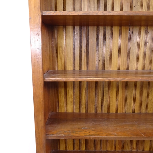 2130 - A large oak open bookcase with 6 fixed shelves, W125cm, H230cm, D40cm