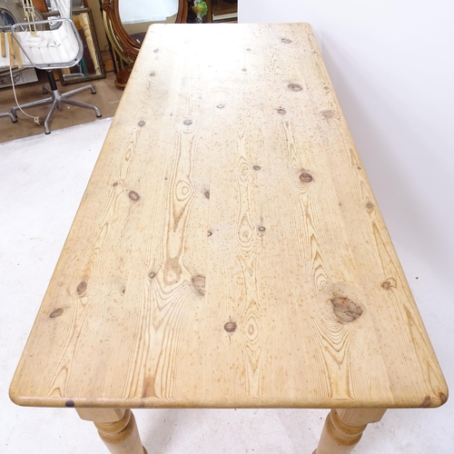 2132 - A pine farmhouse kitchen table on turned legs, L183cm, H75cm, D77cm