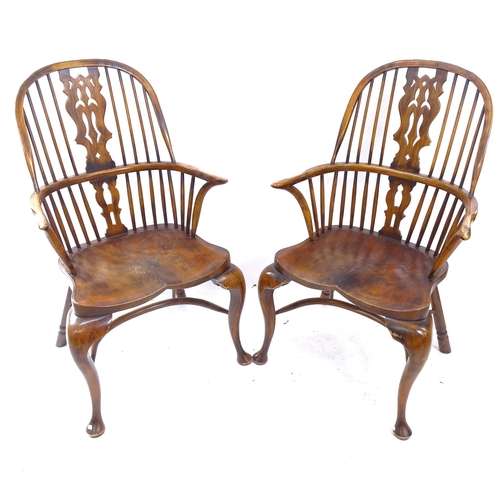 2159 - A pair of Windsor double bow arm chairs, with elm seat and crinoline stretcher