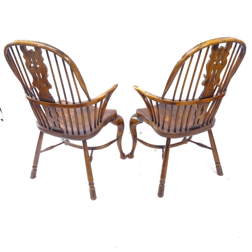 2159 - A pair of Windsor double bow arm chairs, with elm seat and crinoline stretcher