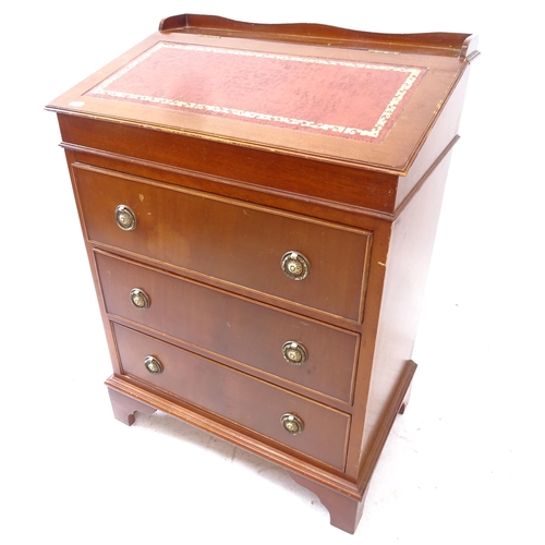 2161 - An early 20th century mahogany writing desk, with tooled and embossed red leather skiver, sliding to... 