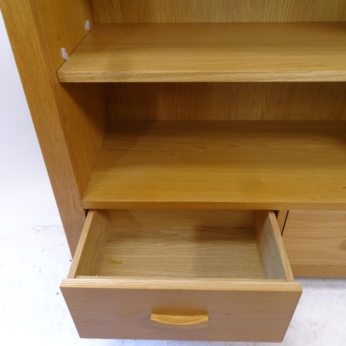 2178 - A modern light oak bookcase, with 2 adjustable shelves and 2 fitted drawers, W105cm, H128cm, D41cm