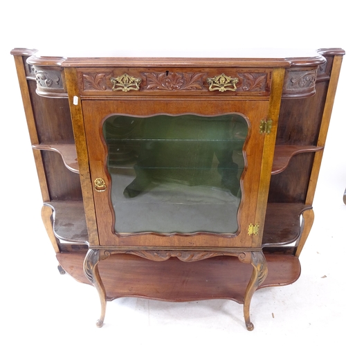 2256 - An Antique mahogany display cabinet of shaped form, with single glazed door, and single frieze drawe... 