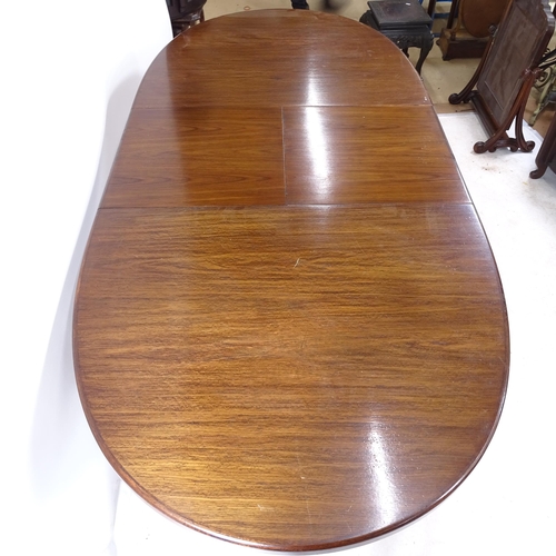 2258 - A mid-century oak oval extending dining table, L152cm extending to 199cm, H74cm, D92cm