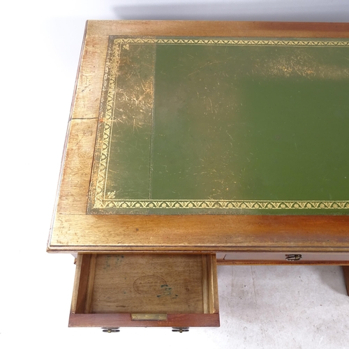 2261 - An Edwardian mahogany pedestal writing desk, with tooled and embossed green leather skiver, and 9 dr... 