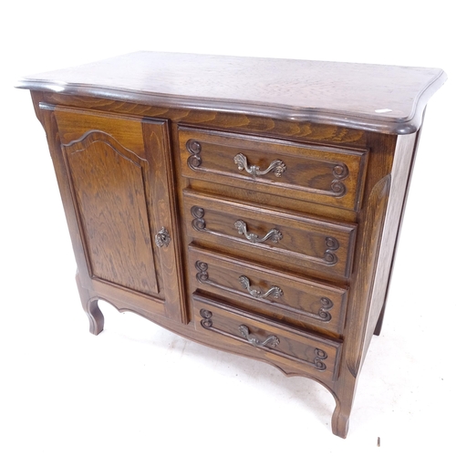 2278 - A reproduction oak cabinet, having a single panelled door and 4 drawers, W84cm, H76cm, D45cm