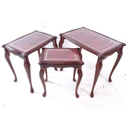 2284 - A nest of 3 leather and glass-top mahogany occasional tables, largest width 60cm, H55cm, D40cm