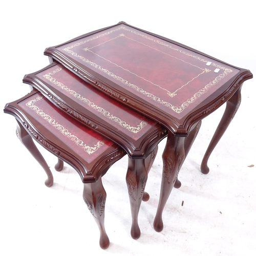 2284 - A nest of 3 leather and glass-top mahogany occasional tables, largest width 60cm, H55cm, D40cm