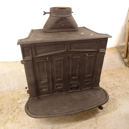 2506 - A cast-iron wood burning stove, with 2 bi-fold doors, W88cm, H101cm, D60cm