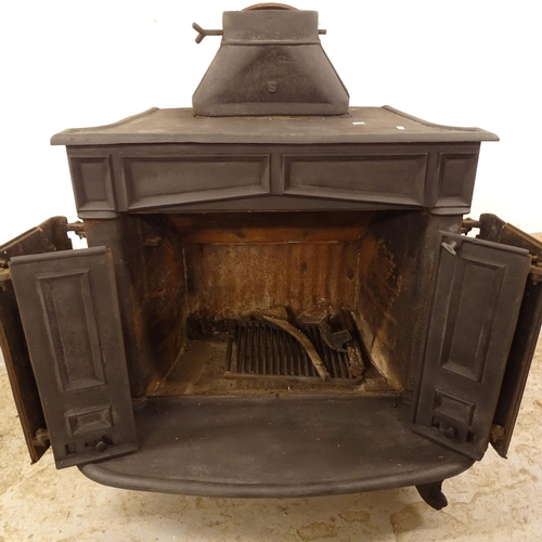 2506 - A cast-iron wood burning stove, with 2 bi-fold doors, W88cm, H101cm, D60cm