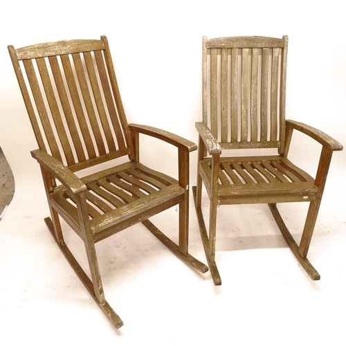 2509 - A pair of weathered teak garden rocking chairs