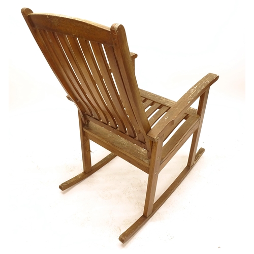 2509 - A pair of weathered teak garden rocking chairs