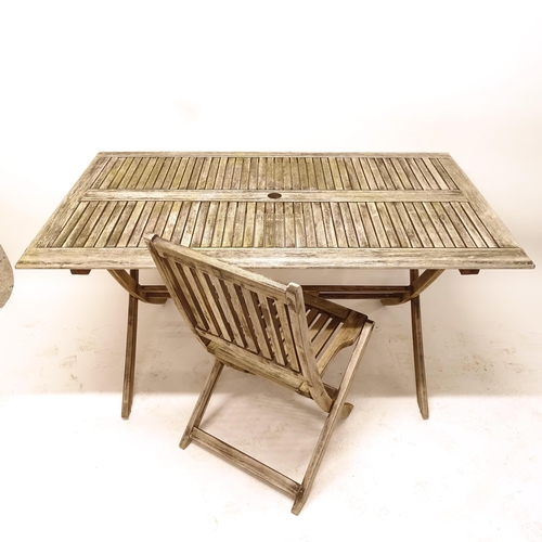 2510 - A rectangular weathered teak garden table, L150cm, H70cm, D86cm, with 4 matching folding garden chai... 