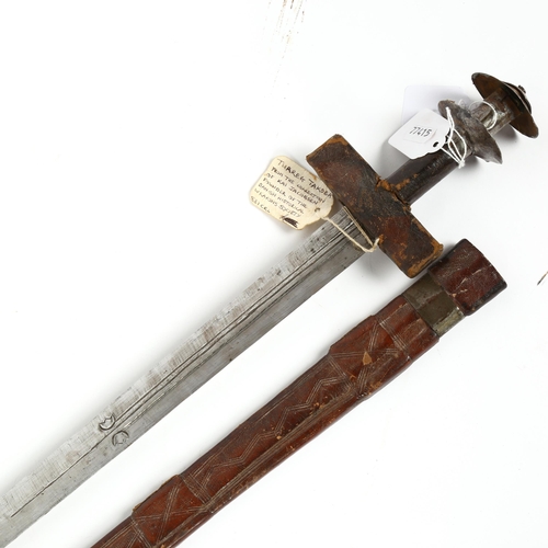 285 - A Berber Tuareg Takoba sword, in leather scabbard, blade length 73cm