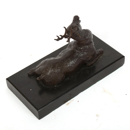 369 - A 20th century patinated bronze sculpture, recumbent stag, unsigned, on black marble base, length 16... 