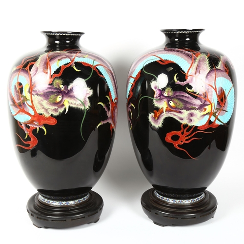 4 - A large pair of Chinese cloisonne enamel dragon vases, on hardwood bases, overall height 52cm