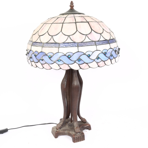 69 - A reproduction Tiffany style leadlight table lamp, with lion paw base, overall height 62cm, shade di... 