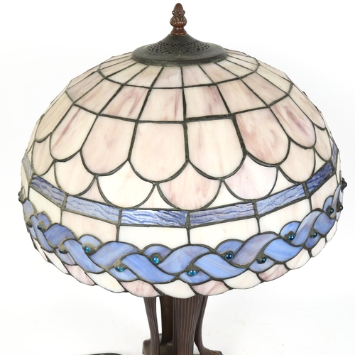 69 - A reproduction Tiffany style leadlight table lamp, with lion paw base, overall height 62cm, shade di... 