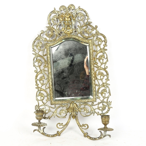 72 - An Antique cast-brass Bacchus wall sconce mirror, probably by Bradley & Hubbard, 44cm x 24cm