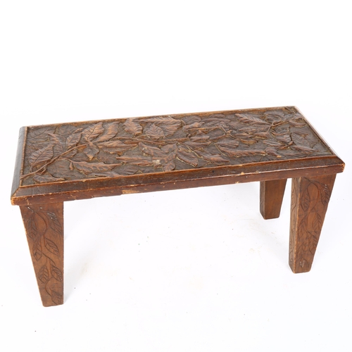 82 - A German Black Forest carved oak leaf stool, W46cm, H24cm, D18cm