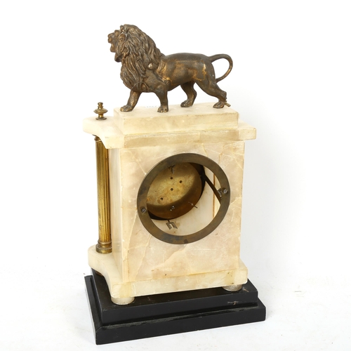 574 - An alabaster clock with brass pilasters surmounted by a spelter lion, on separate stand