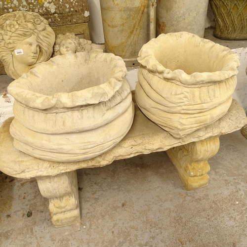 2671 - A pair of large concrete sack-shaped garden planters, W40cm, H25cm