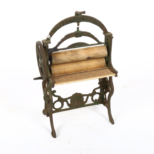 599 - A miniature cast-iron mangle with wooden rollers, height 27cm