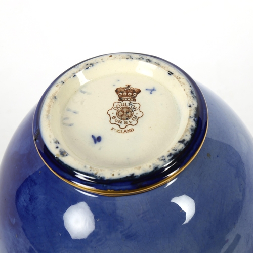 718 - A Doulton Burslem blue and white ceramic vase, with hand painted and gilded decoration, model no. 65... 