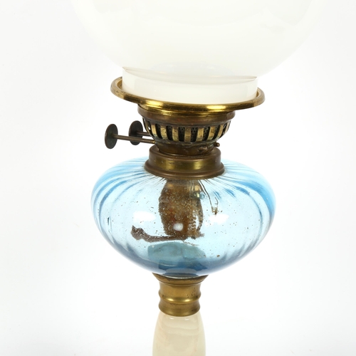 732 - An Antique brass Sherwood oil lamp, with white onyx stem, blue glass font, milk glass shade and clea... 