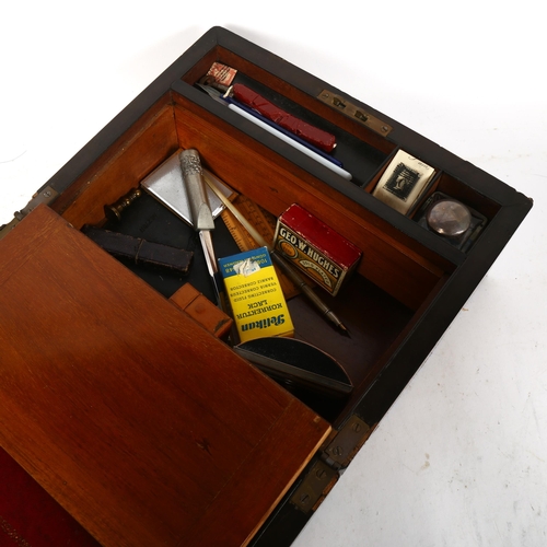 738 - A Victorian walnut brass-bound writing slope, containing inkwells, desk blotter, and related items