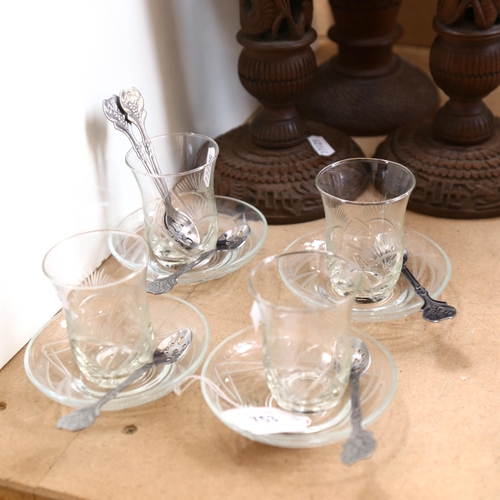 753 - A set of 4 engraved coffee glasses and saucers, with a set of 6 white metal spoons