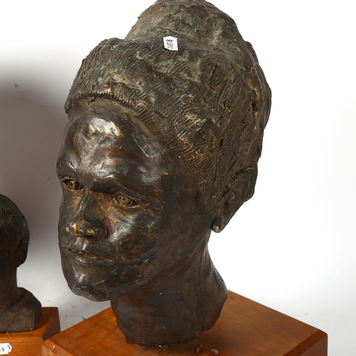 868 - 3 sculptured heads mounted on wooden plinths, largest 42cm