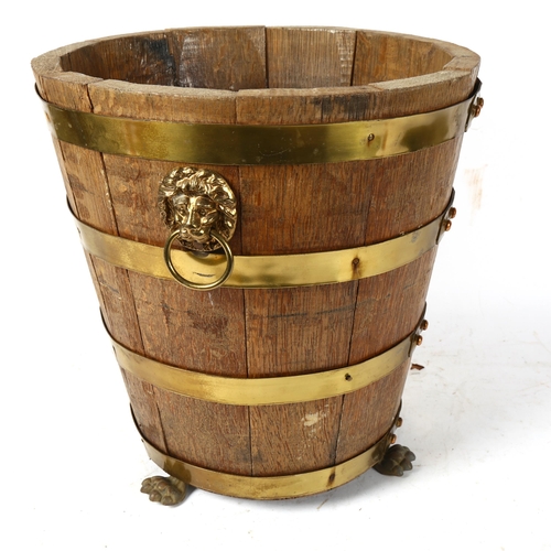 902 - A coopered oak bucket with lion mask ring handles, height 34cm, and a Vintage shooting stick