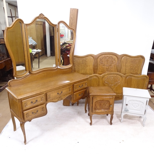 2302 - A French oak bedroom suite, comprising a 4-door armoire with carved shell and acanthus leaf decorati... 