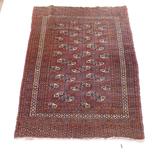 2375 - A red ground Tekke design rug, with symmetrical pattern, 160cm x 115cm