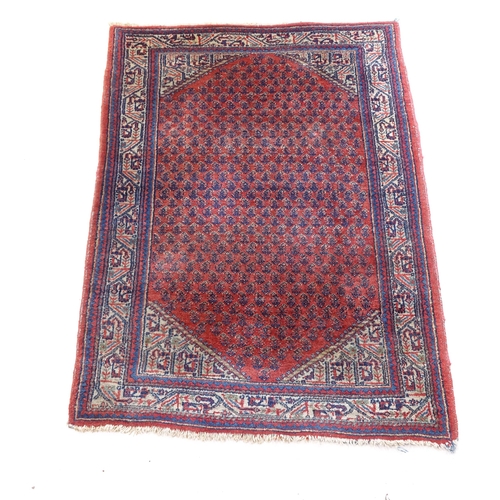 2376 - A red ground wool Persian style rug, 145cm x 100cm