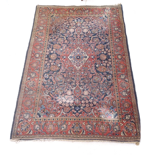 2377 - A red ground wool Kashan rug, 206cm x 135cm