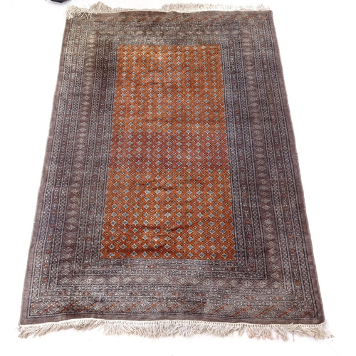 2380 - A brown ground wool Persian style rug, 182cm, x 125cm