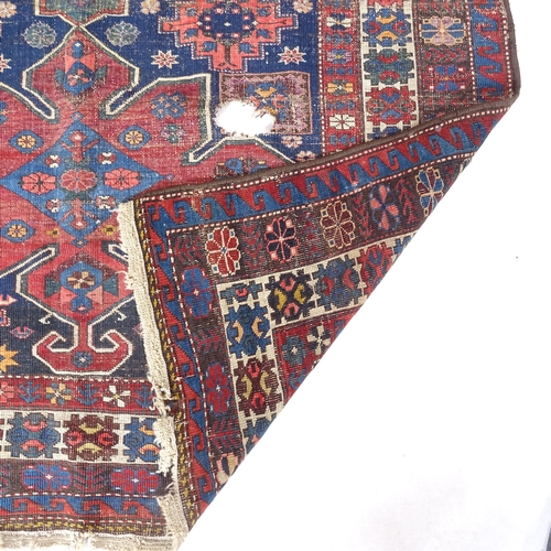 2382 - A red ground Kasak Caucasian rug, 180cm x 140cm