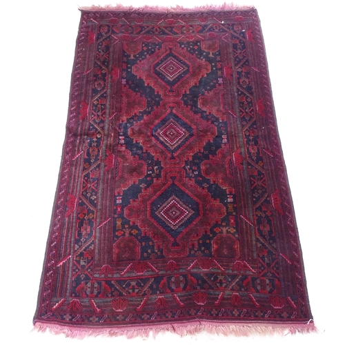 2384 - A red ground Turkish design rug, with symmetrical pattern, 190cm x 110cm