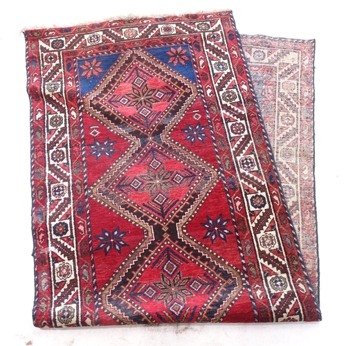 2387 - A red ground wool Afghan design runner, 305cm x 110cm