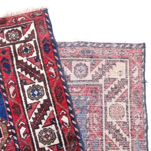 2387 - A red ground wool Afghan design runner, 305cm x 110cm