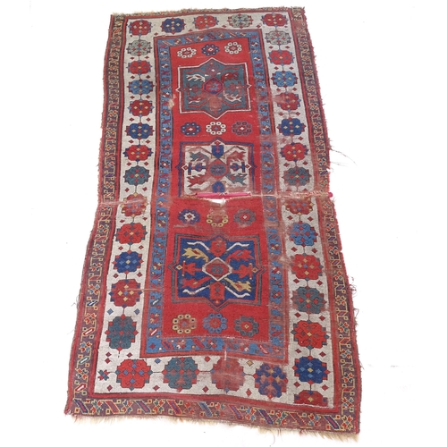 2391 - An Antique red ground Turkish Kazak rug (for restoration), L214cm