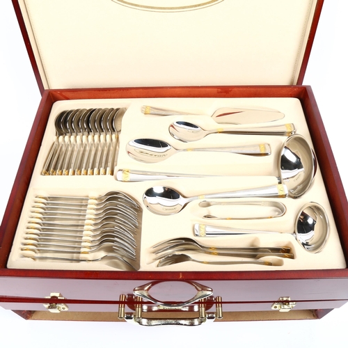 1200 - PRIMA - a canteen of stainless steel and gold plated cutlery for 12 people, in fitted case (unused)