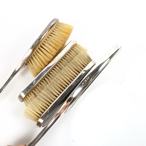 1212 - A George V silver and tortoiseshell 4-piece dressing table brush and mirror set, London 1919