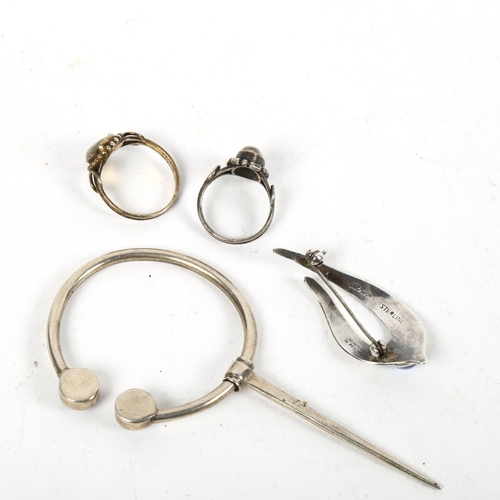 1284 - ULRICH - a stylised silver brooch, a silver and moonstone set cloak pin, and 2 silver stone set ring... 