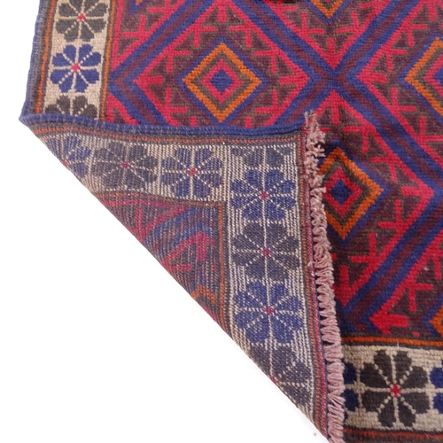 2305 - A red and blue ground Baluchi rug, 147cm x 90cm