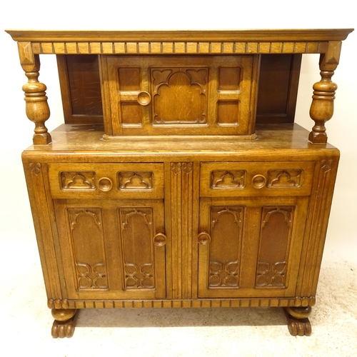 2733 - A 1920s oak court cupboard, with 3 carved and panelled doors, and 2 fitted drawers, W122cm, H135cm, ... 